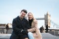A couple enjoying their photoshoot in front of the iconic Tower Bridge