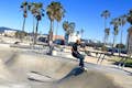 Un skateur fait du skateboard au skate park de Venice Beach.