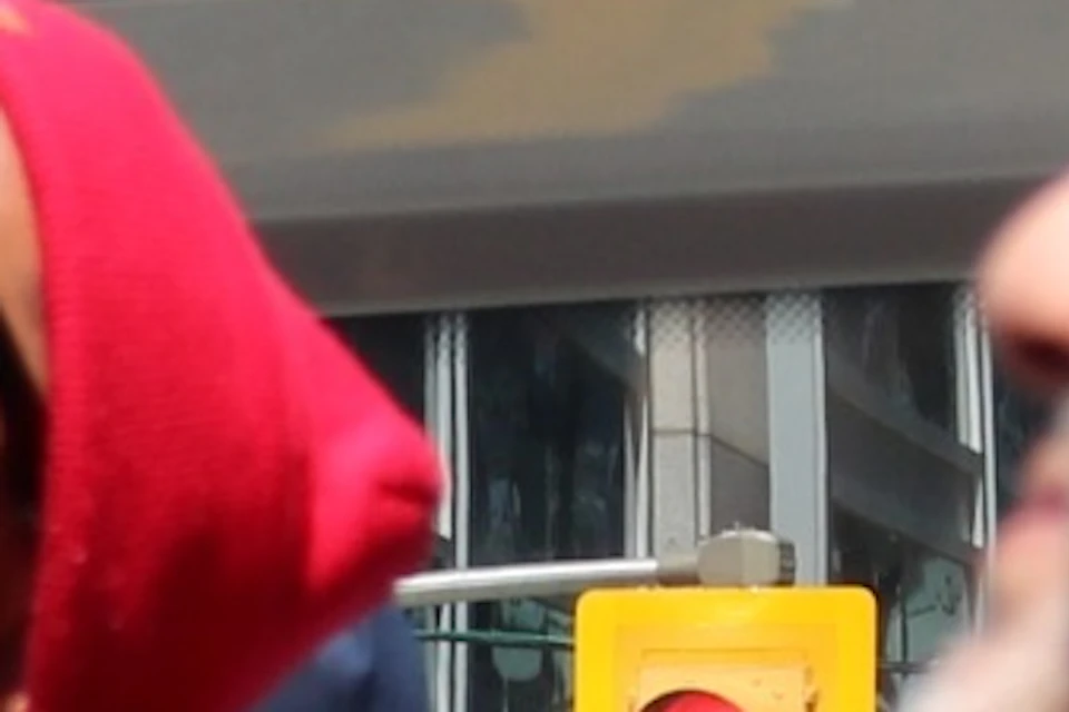 Tour Guide pointing to an interesting sight on the upper level of a double-decker tour bus
