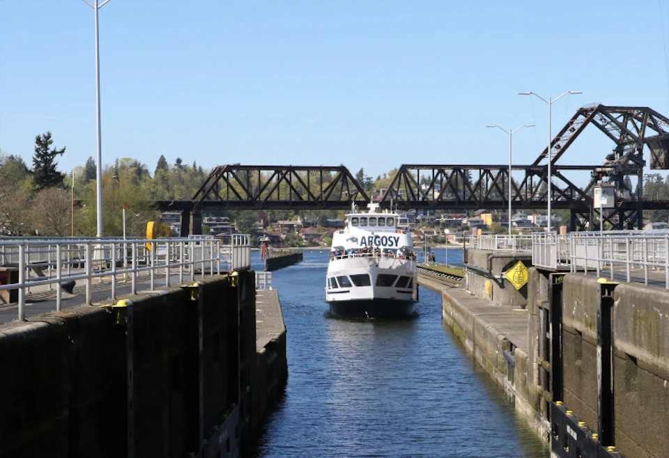 An Argosy boat approaches the Locks from the saltwater side - the concrete walls of the lock chamber are as high as the boat