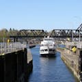 An Argosy boat approaches the Locks from the saltwater side - the concrete walls of the lock chamber are as high as the boat