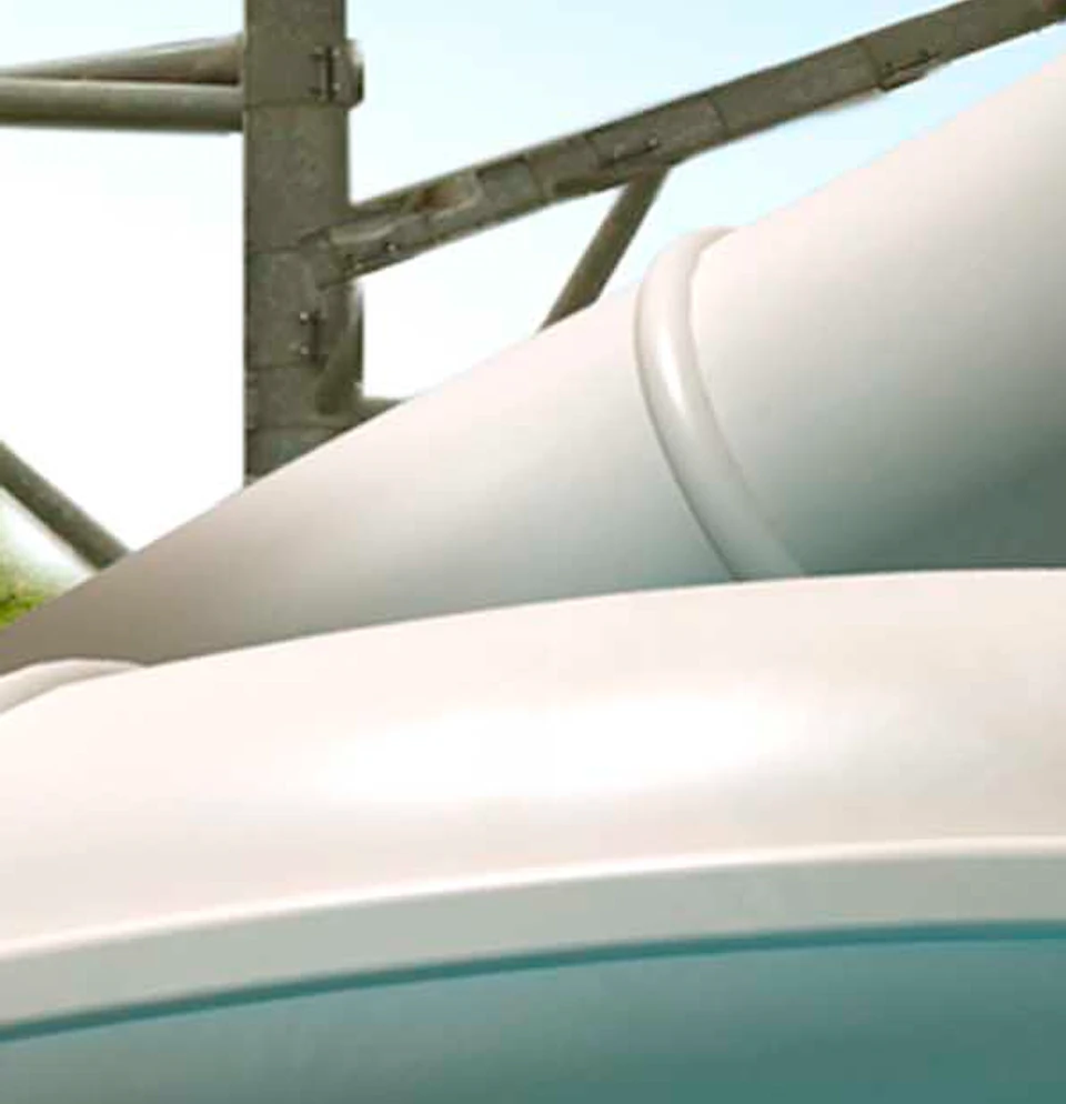 A girl on a water slide in a tube with big cats including a black panther and jaguars in the foreground, and a water park backdrop.
