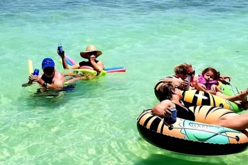 Relaxing on rafts with pool noodles in clear waters—a perfect snapshot of carefree bliss and summer leisure.
