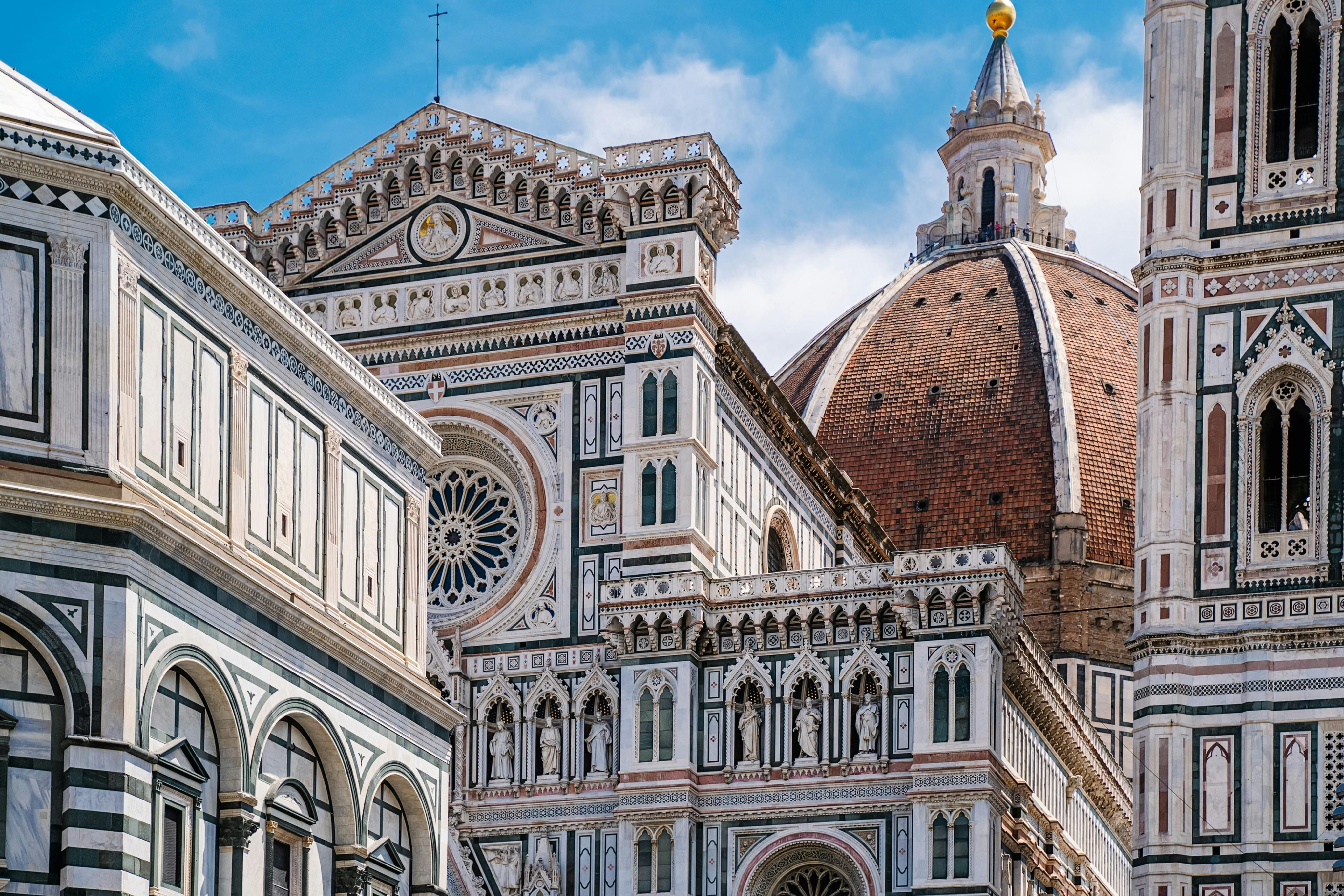 Close-up of Florence Cathedral, showcasing its detailed Gothic exterior with intricate patterns and the large brick dome.