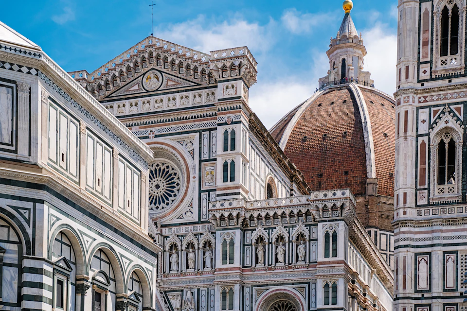 Close-up of Florence Cathedral, showcasing its detailed Gothic exterior with intricate patterns and the large brick dome.