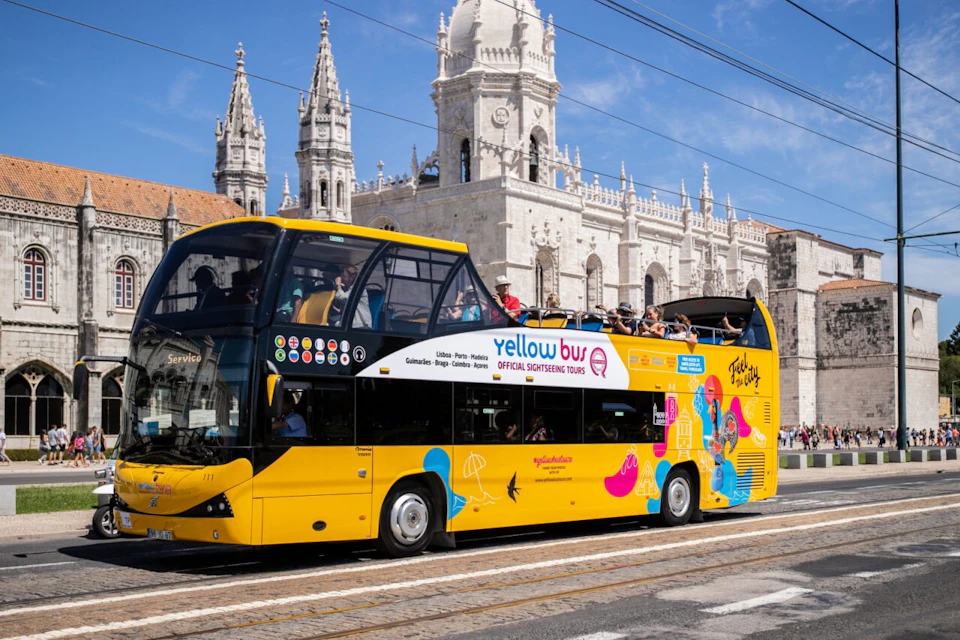 Experience Lisbon like never before with the Yellowbus hop-on hop-off tour! In this image, a vibrant Yellowbus is seen parked
