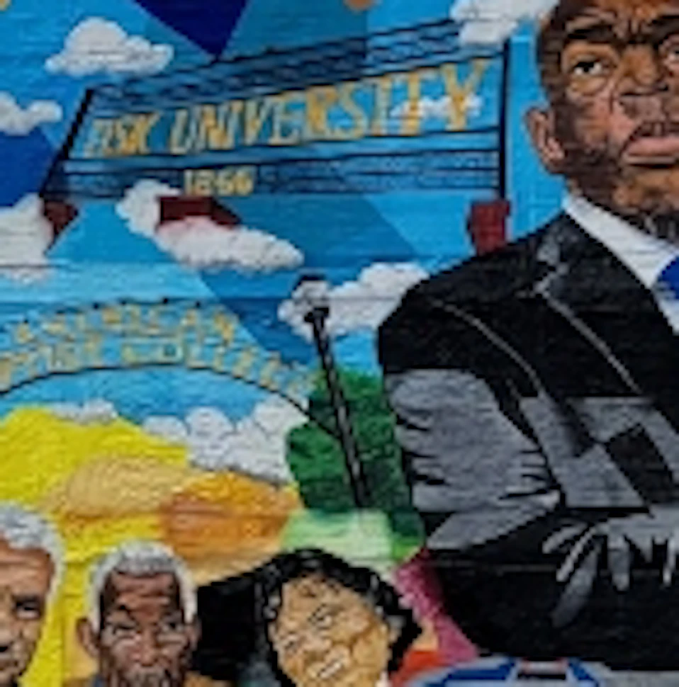 Large mural of prominent figures and a “Good Trouble” message on a building wall beside an iPhone 13 ad, with skyscrapers in background.