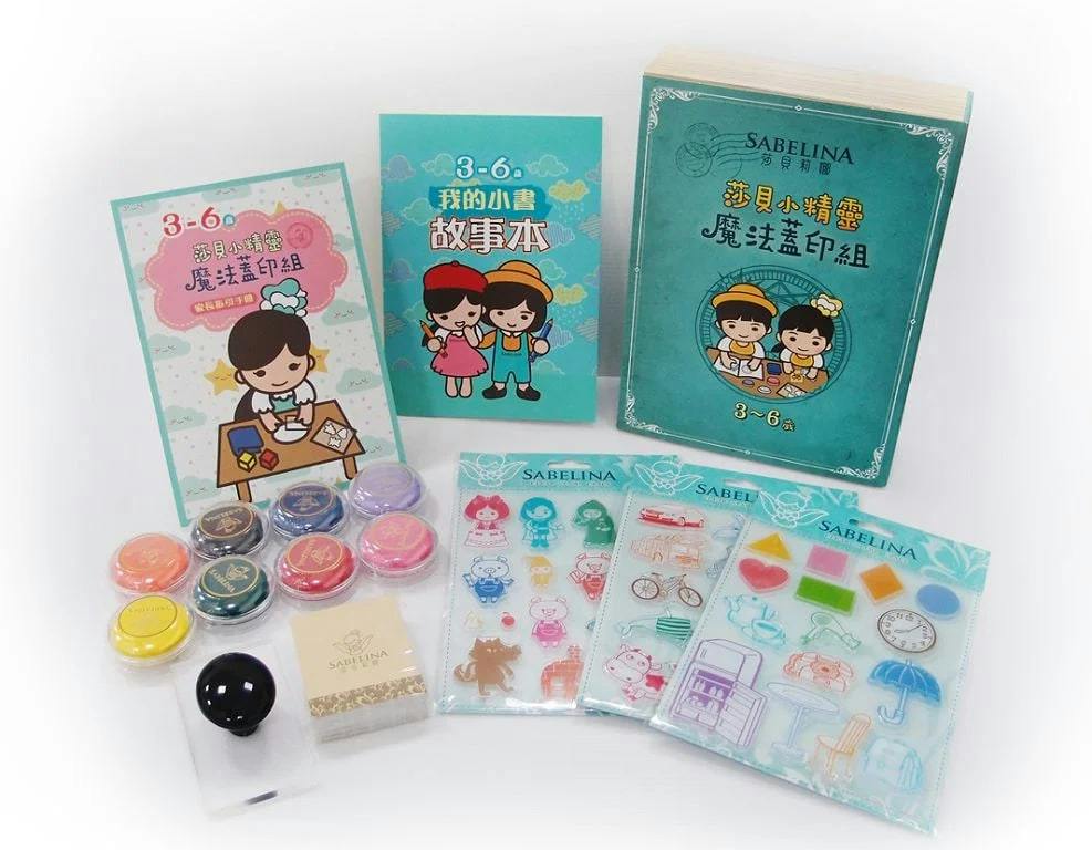 A set of children's activity materials, including booklets, colorful stamps, and decorative sheets, displayed on a surface.