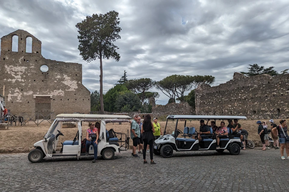 Golf cart in front of Cecilia Metella's tomb