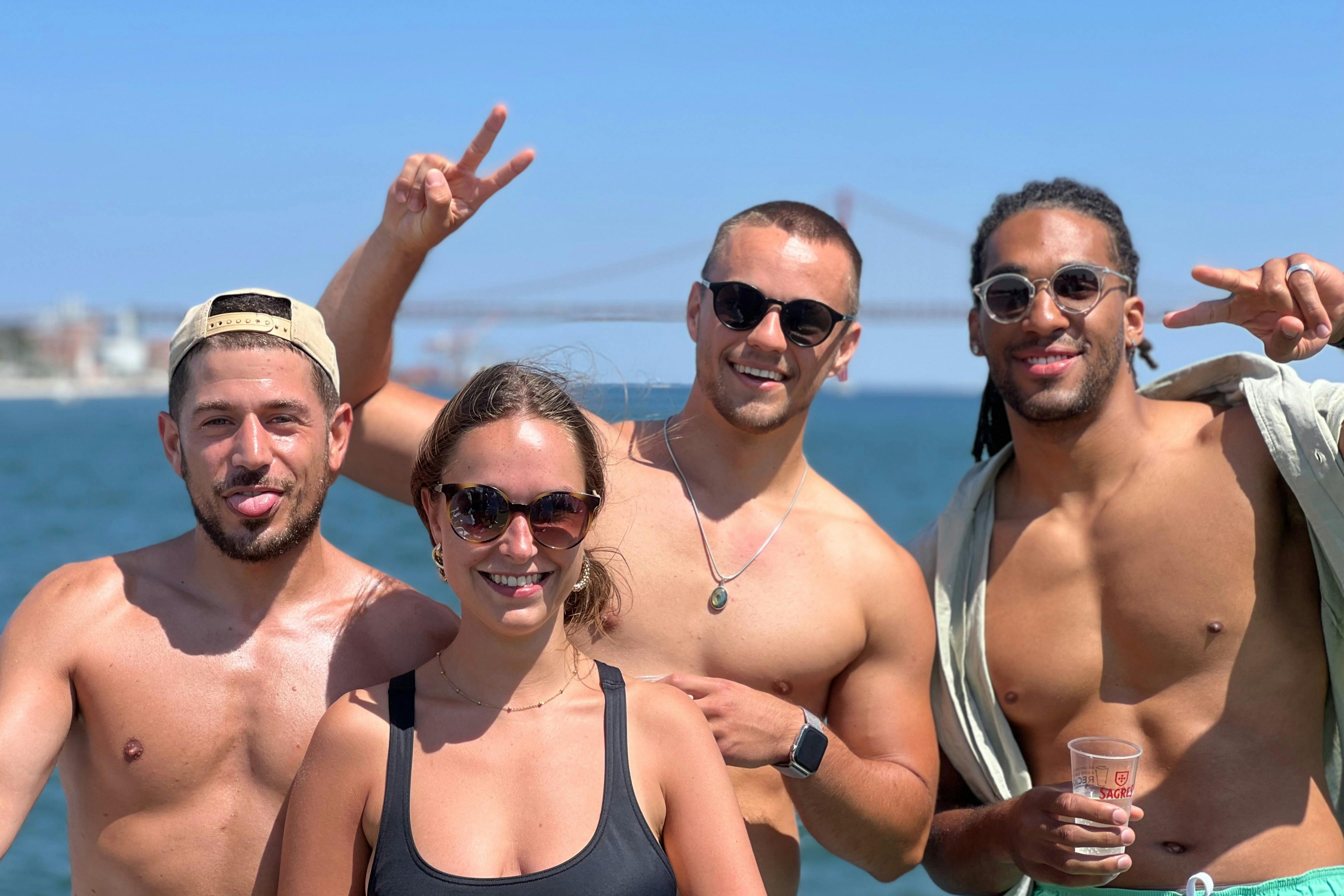 Group of young people having fun on the boat party Lisbon on the Tagus River