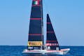 An America's Cup sailboat is training on the water in the Mediterranean.