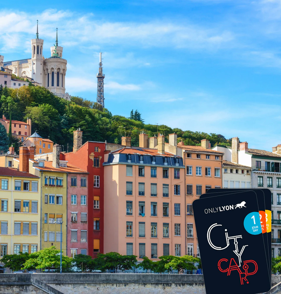 Colorful buildings line a riverbank, with a church on a hill and a tower in the background. A "City Card" is prominently displayed.