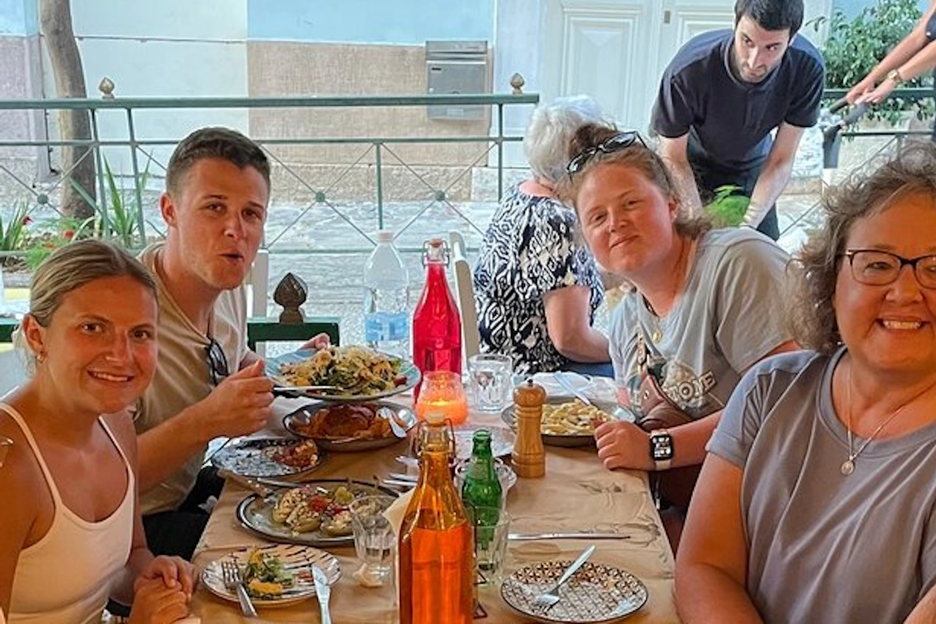 Our tour guide is having dinner at a traditional Greek tavern.