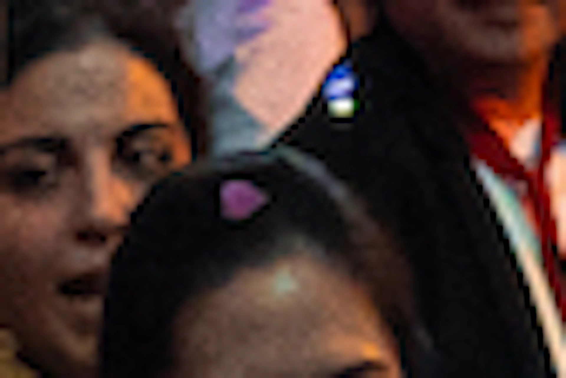 A large crowd gathers under colorful lighting with confetti falling. A sign reads "#LSCAFERDARK" in the background.