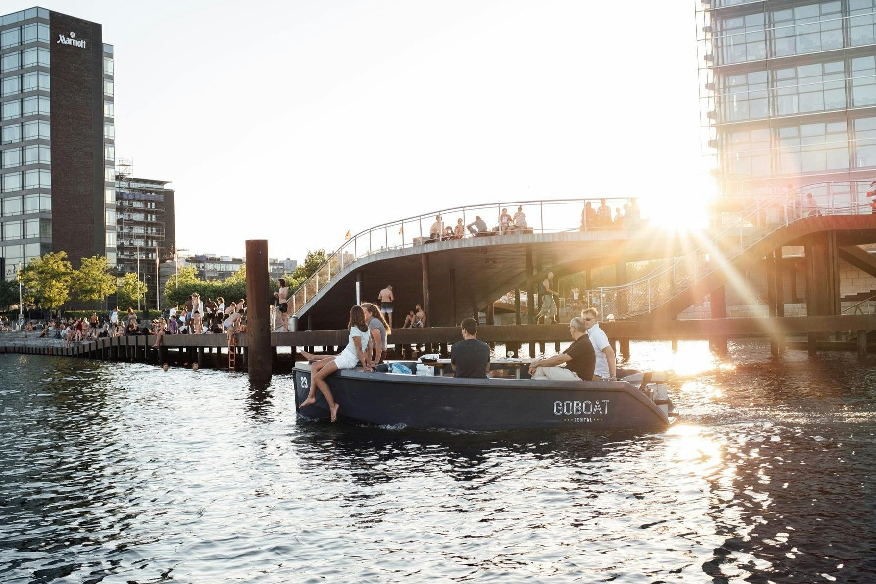 Amigos curtindo o pôr do sol em um GoBoat em Copenhague
