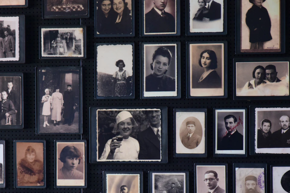 A collection of vintage black-and-white and sepia-toned portraits arranged on a black background.