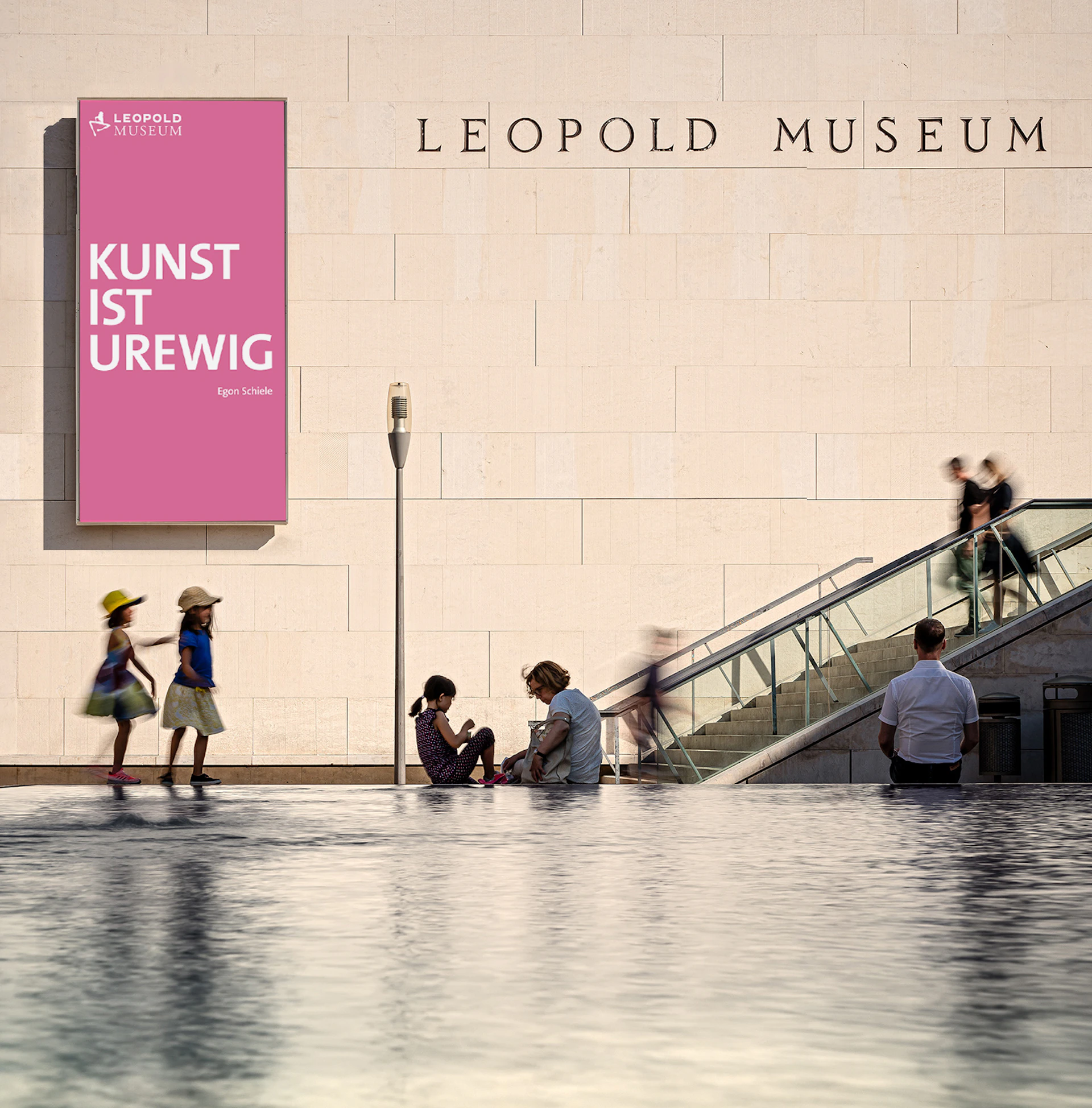 People walking and sitting near a reflective pool outside the Leopold Museum. A pink sign reads "Kunst Ist Urewig."