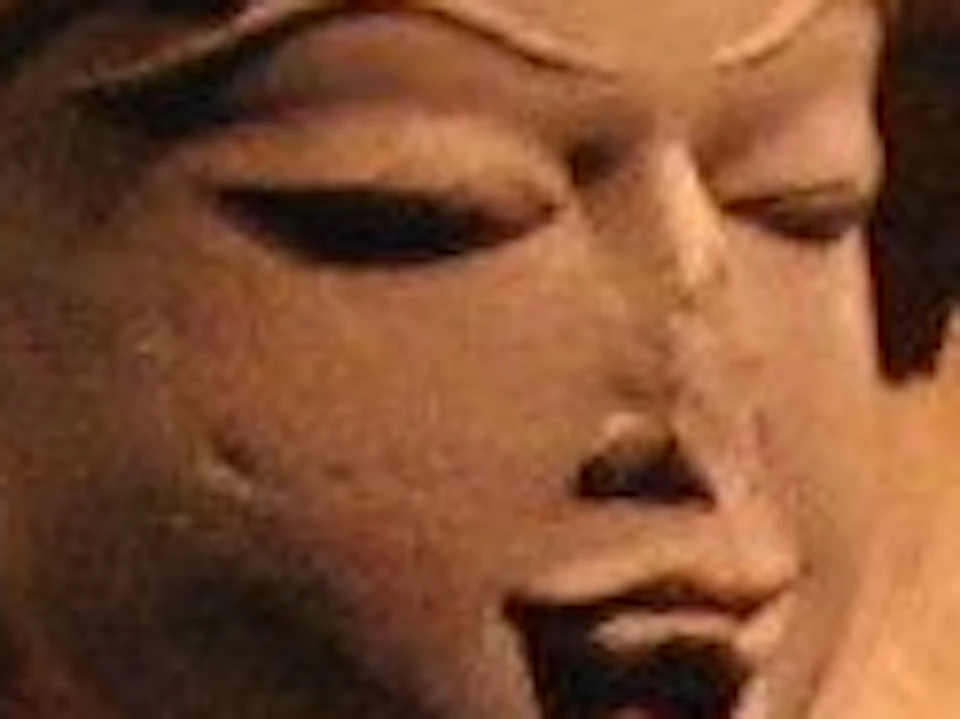 Stone sculptures of Hindu deities displayed in a dimly lit museum exhibit, highlighting intricate details and craftsmanship.