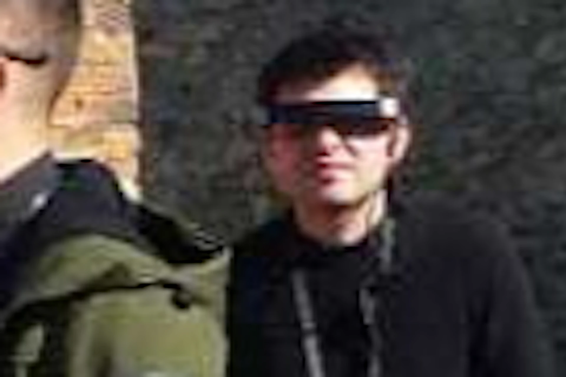 A group of people wearing VR headsets explore ancient ruins under a clear blue sky.
