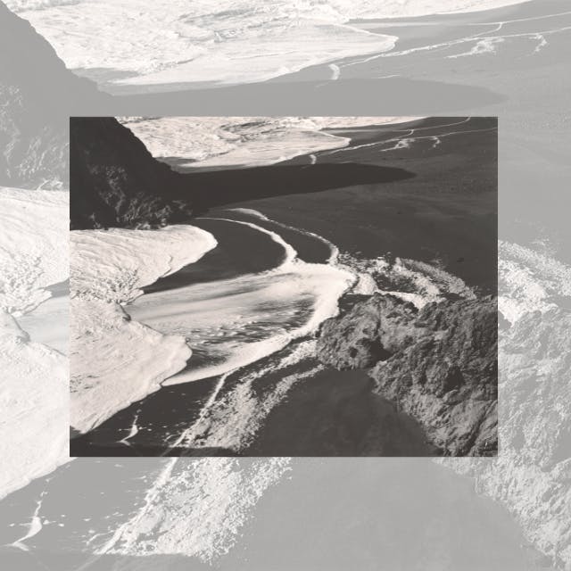 A black-and-white landscape featuring a river winding through rocky terrain surrounded by contrasting textures.