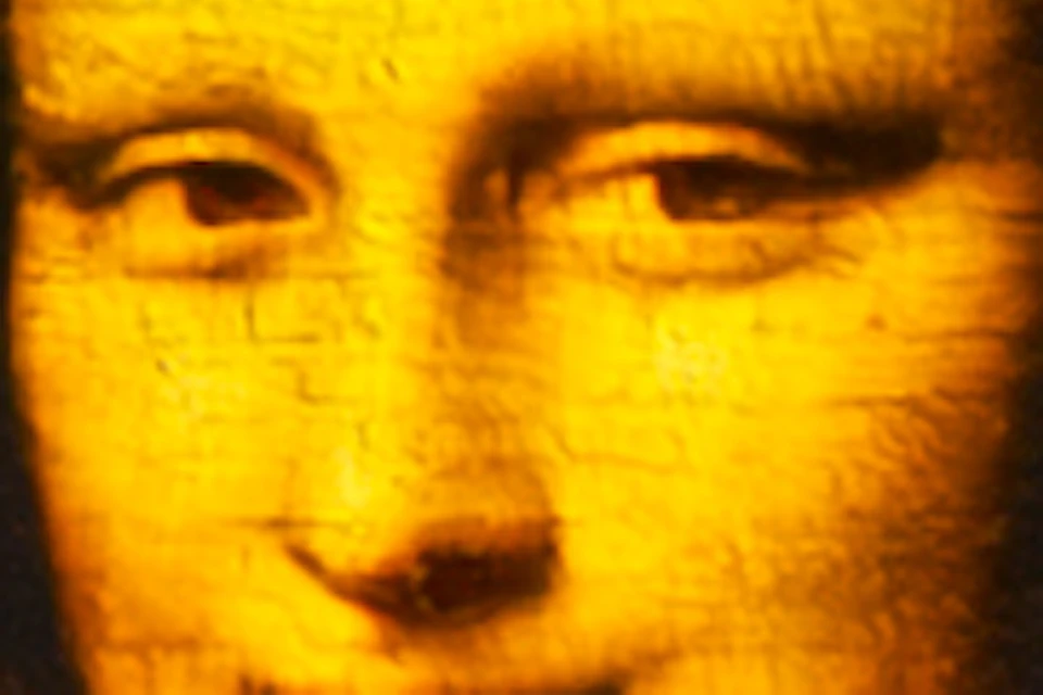 A dimly-lit exhibition space featuring large projections of the Mona Lisa and its background on arched walls.