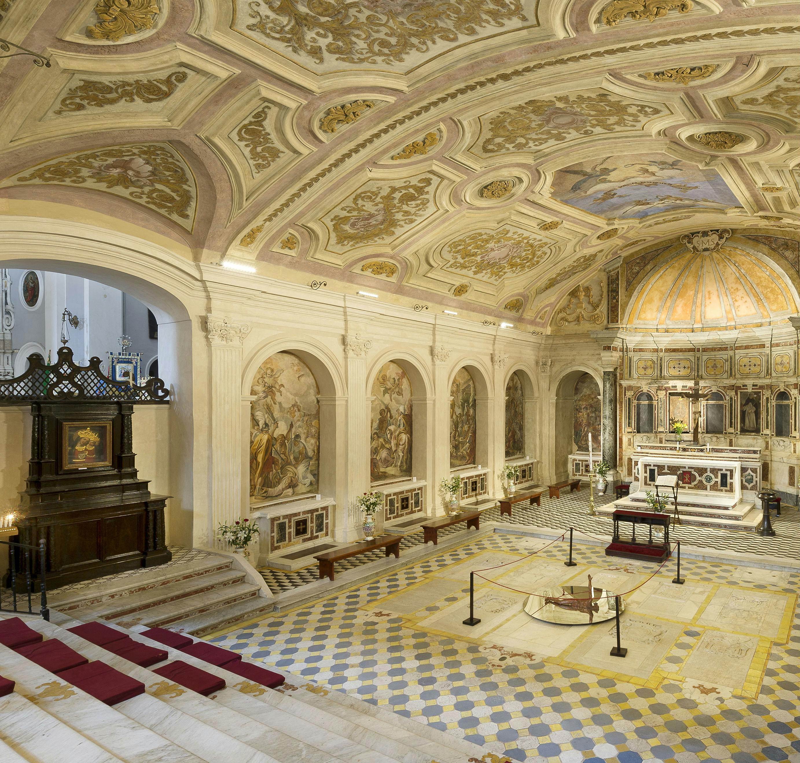 Chapelle ornée d'un plafond détaillé, de fresques sur les murs, d'un autel à l'arrière et de bancs et chaises disposés à l'avant.
