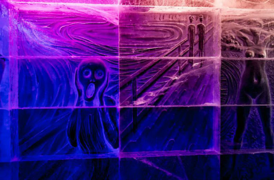 An ice sculpture of Edvard Munch's "The Scream," illuminated with purple and blue lights, depicting a person with a shocked expression.