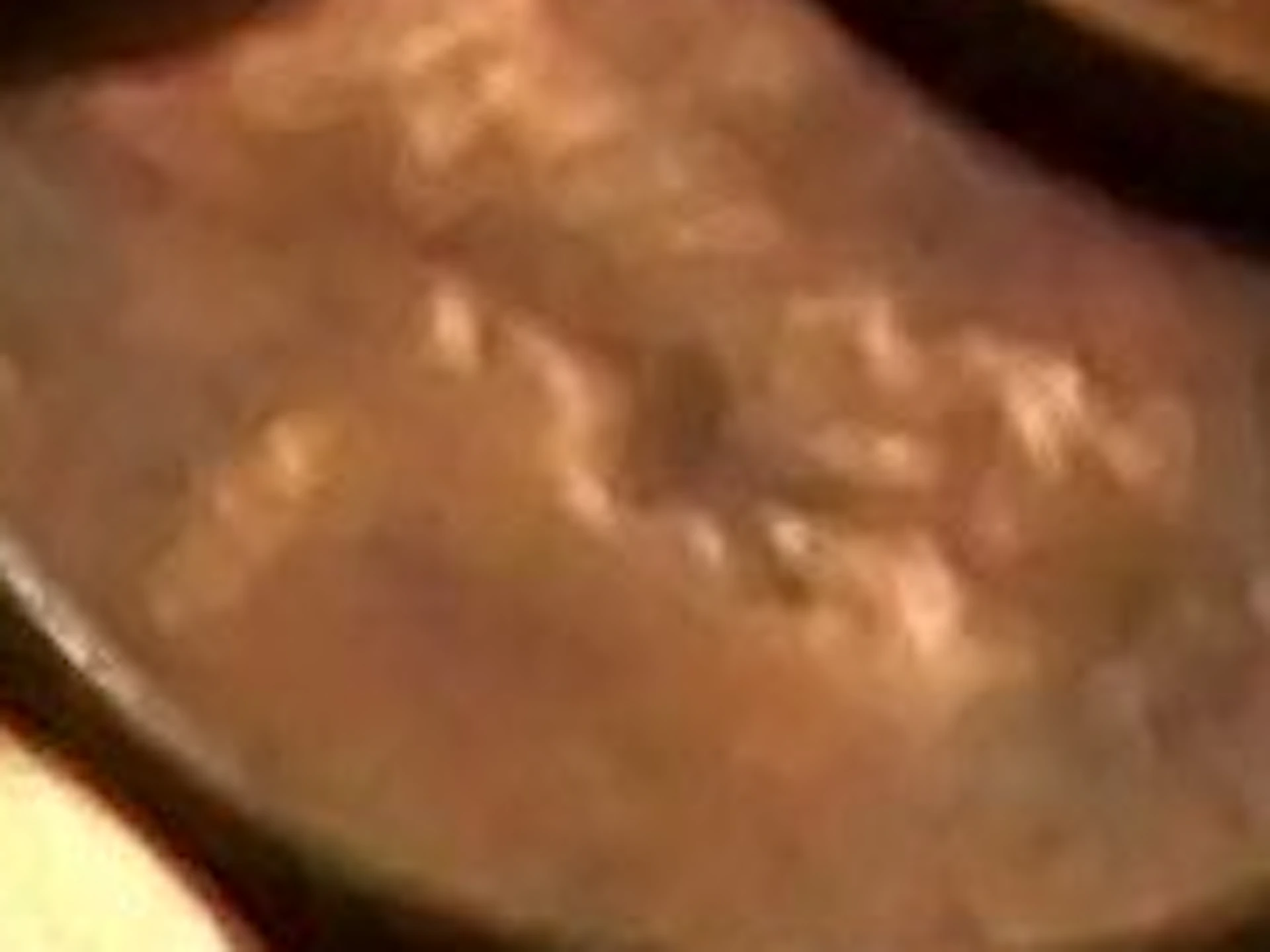 A large pile of U.S. pennies, most showing Lincoln's profile, scattered closely together.