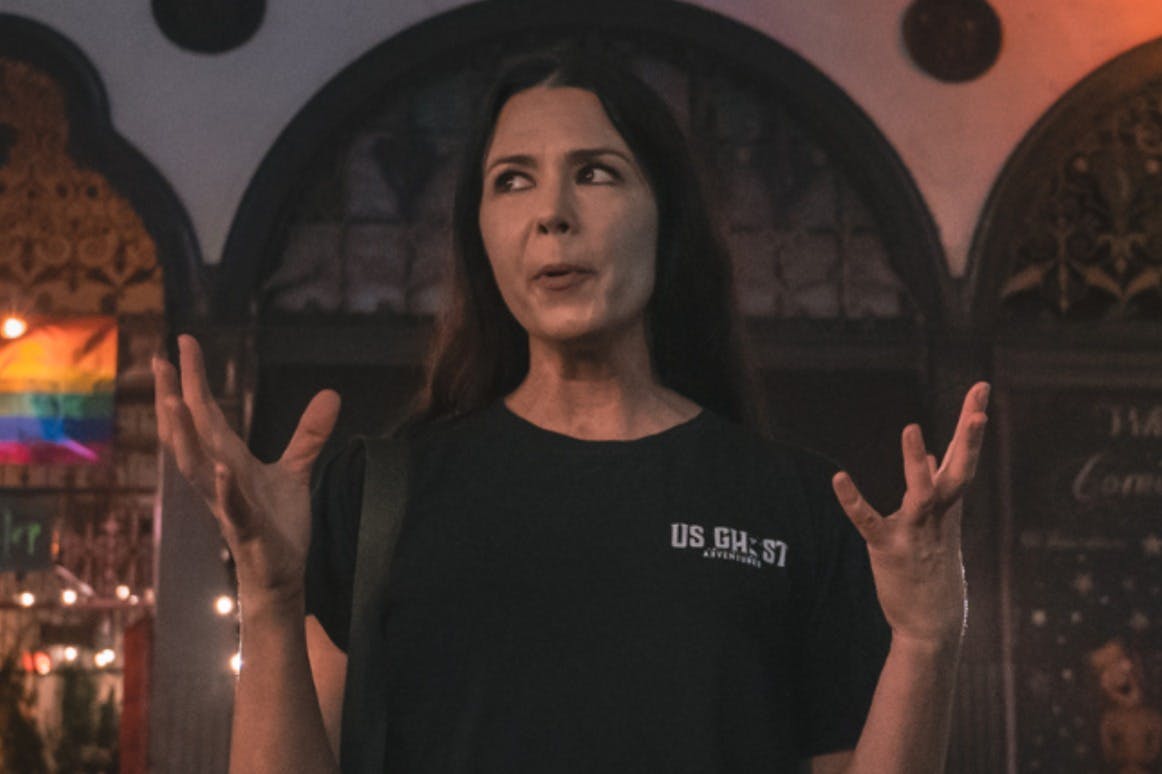 Tour guide expressing with her hands while telling a story to her group