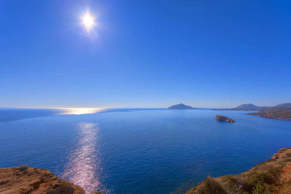 Sun reflecting on the Aegean Sea from Cape Sounio
Sparkling water stretches to the horizon under a clear blue sky.