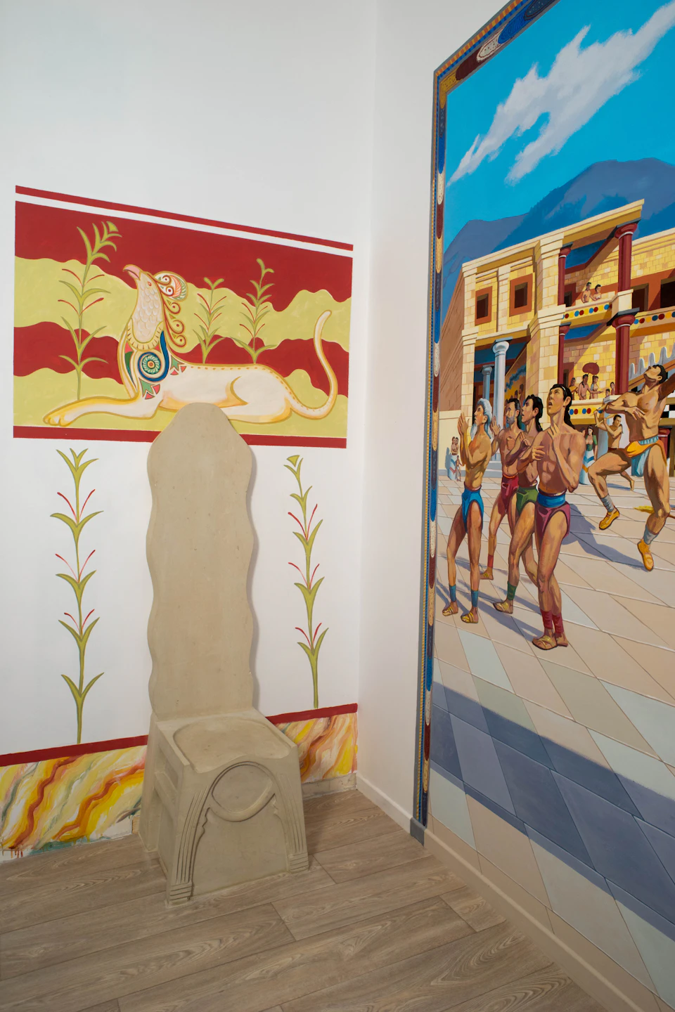 A room with an ancient Greek mural depicting athletes and a decorative wall with an intricate painting of a mythical creature.