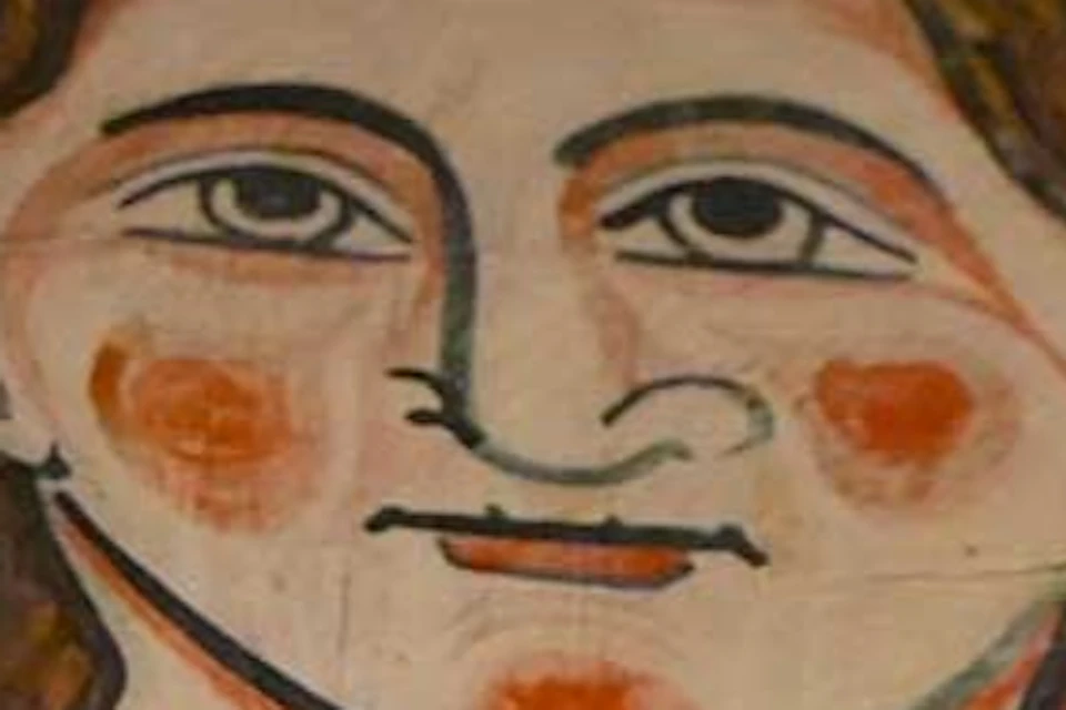 A painted wooden panel featuring a stylized depiction of a face surrounded by intricate patterns and vibrant colors.