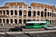 green line bus tour in front of the Colosseum