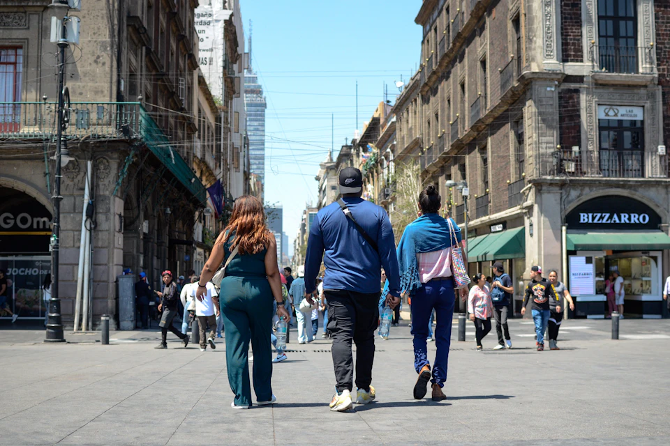Guests stroll along a lively pedestrian street in Mexico City's historic center.