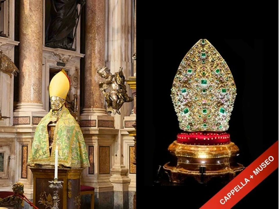 An ornate church interior showing a statue in bishop attire on the left and a jeweled mitre on a pedestal on the right.