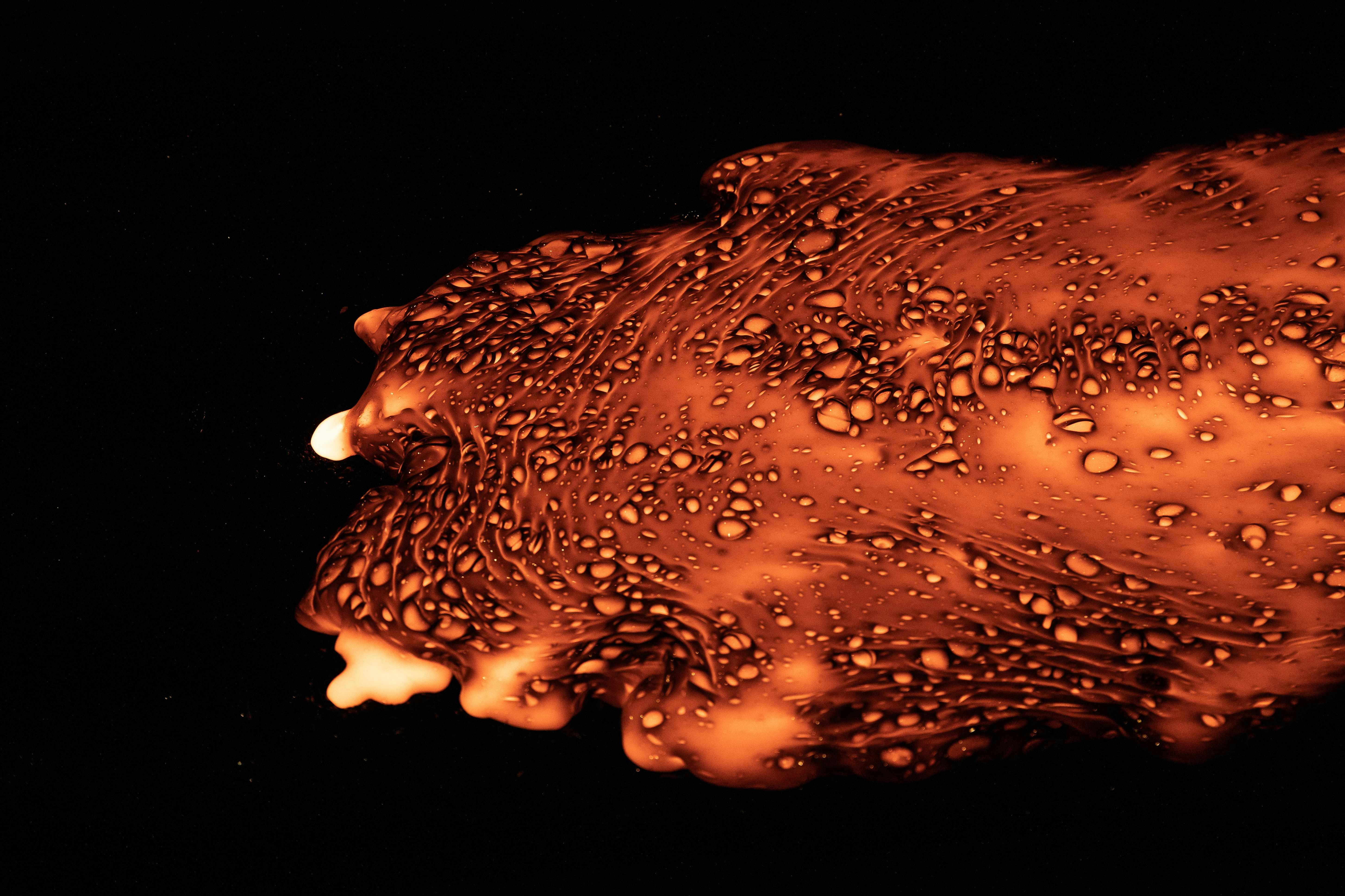 Molten lava is shown flowing safely indoors at Lava Show in Iceland. 