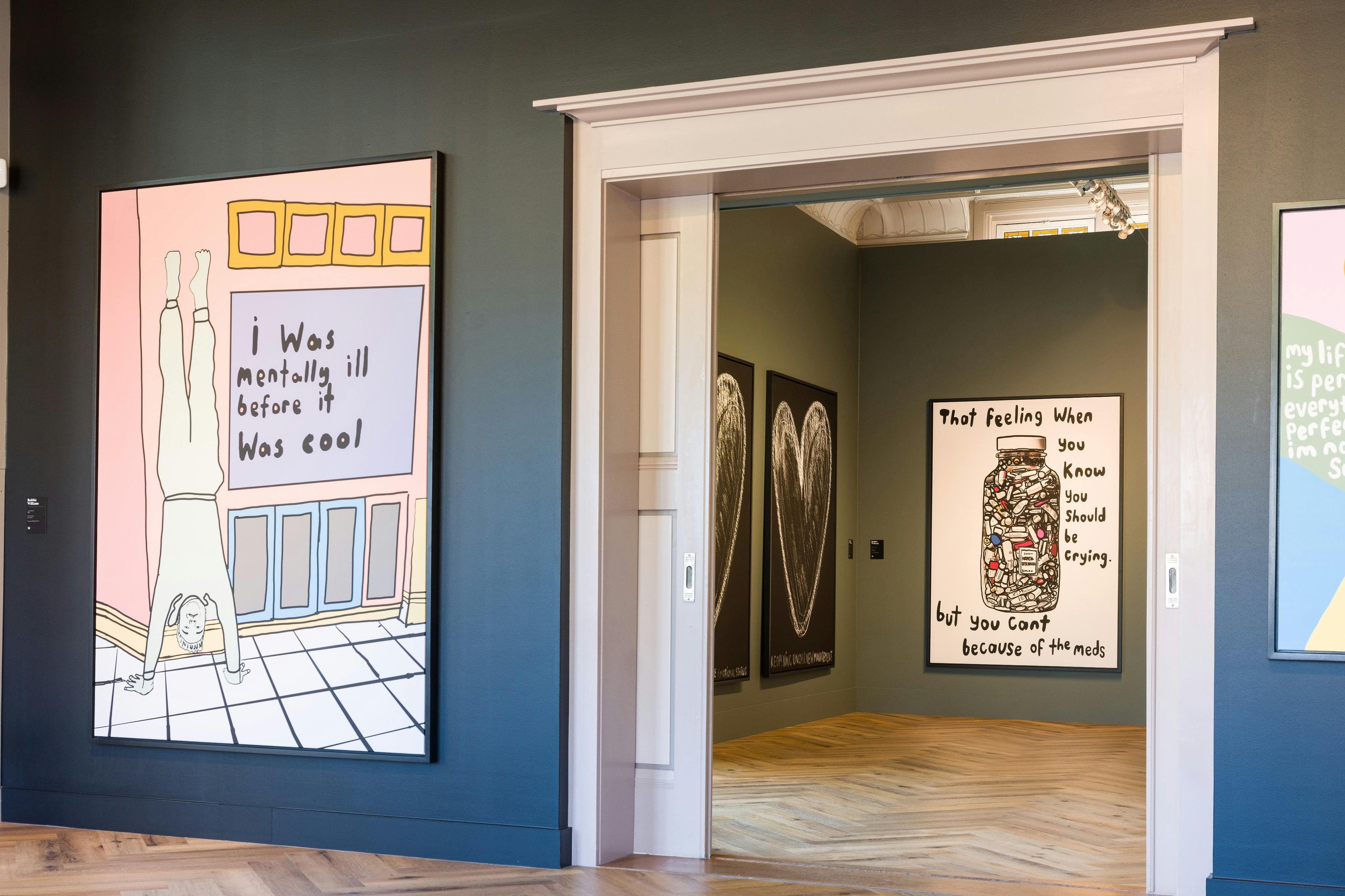 Gallery with modern artwork, including a framed piece stating, "I was mentally ill before it was cool." Another artwork with a jar and text.