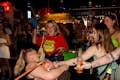 A picture of a Pub Crawl group playing limbo with one of our staff members.