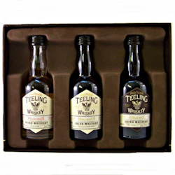 Tre miniflaskor Teeling Irish Whiskey (Single Grain, Small Batch, Single Malt) i en brun låda.