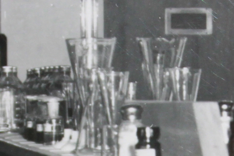Three nurses in a laboratory setting, handling various glassware and conducting experiments.