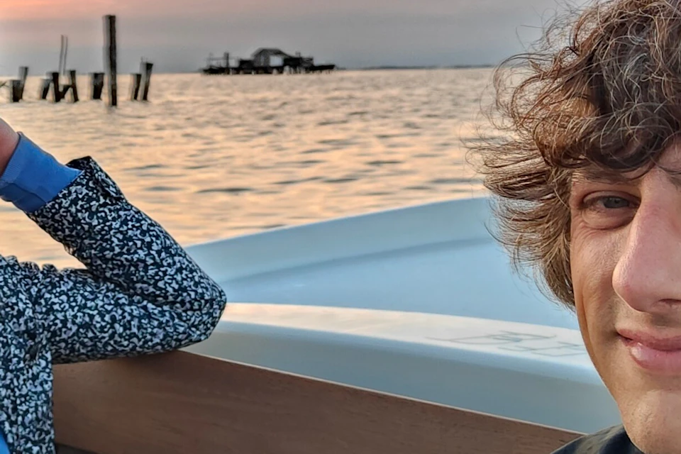 Customers during boat tour with beautiful sunset in the background