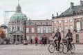Two people on bikes in Amalienborg Square