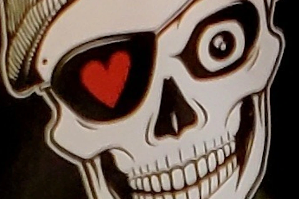 A rainbow flag with "St. Pauli Office" and a skull wearing a beanie in a circle at the center.