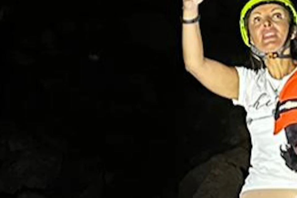 visit of a lava flow cave with helmets and torches