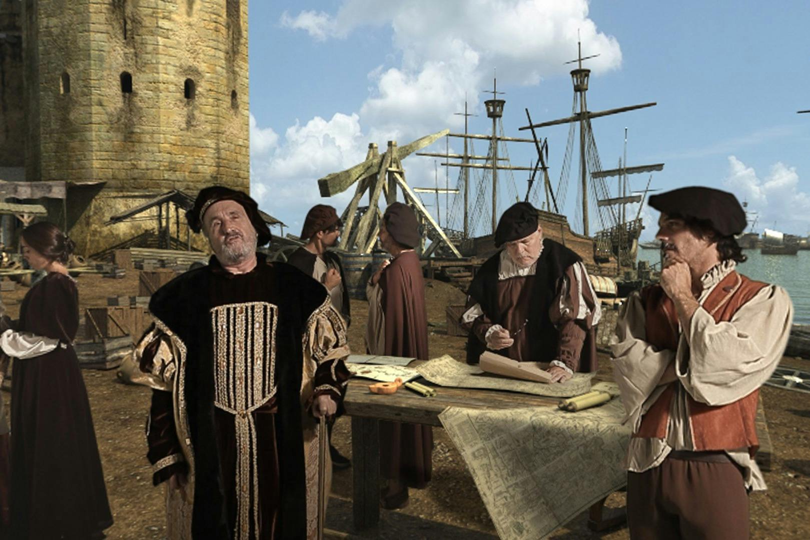 Persone in abiti medievali che lavorano vicino a un tavolo di legno con mappe, una torre di pietra e una grande struttura di legno sullo sfondo.