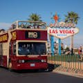 hop on hop off tourist bus by the vegas sign