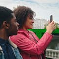 Two people on an open top bus taking a photo