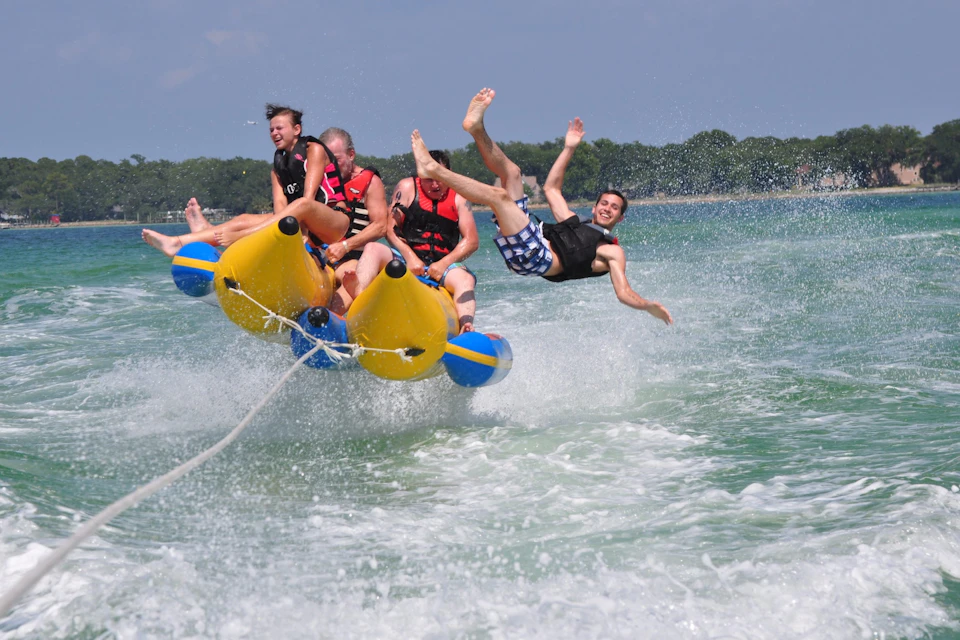 Sit or lie on the banana boat as it speeds across the water, often bouncing and splashing.