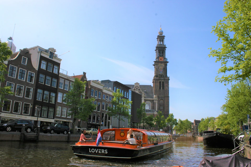 Lovers are cruising on a canal in a boat.