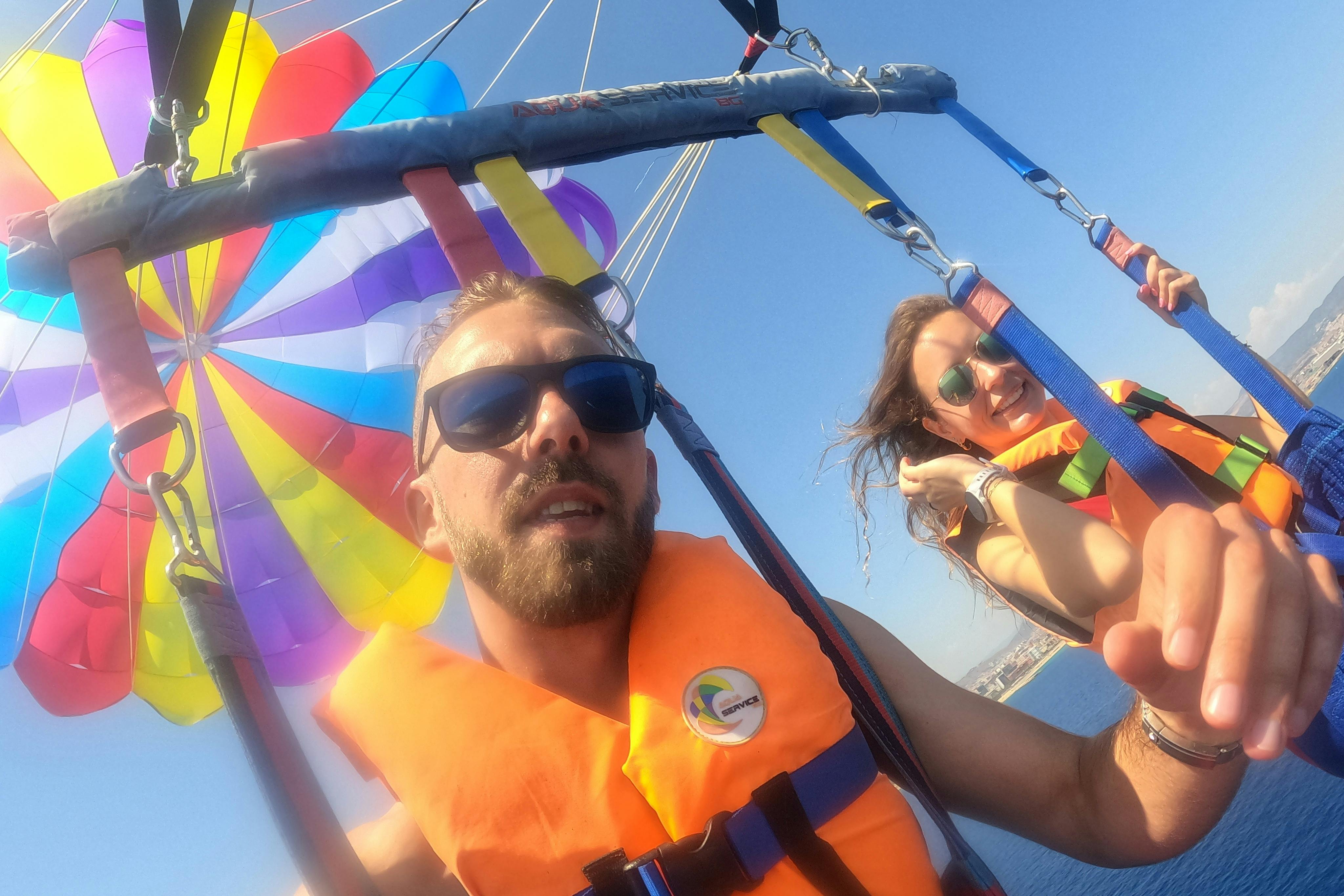 A couple enjoying a parasailing flight